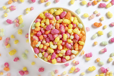 Rainbow drops - multicolored rice confectionery in bowl on white background, top viewの写真素材