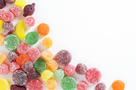 Fruit flavored pastilles with sugar on white background, top view with copy spaceの写真素材