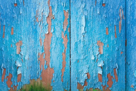 Vintage blue wood background with peeling paint.
