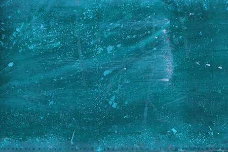 Slightly worn and scratched turquoise background with streaks of paint, turquoise abstract grunge backgroundの写真素材