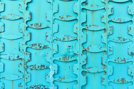 Vintage turquoise metal background with rusty, recurring itemsの写真素材