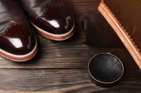 leather shoes on table with polishing equipment. Fashion shoes handmade. Wax. Wooden backgroundの写真素材