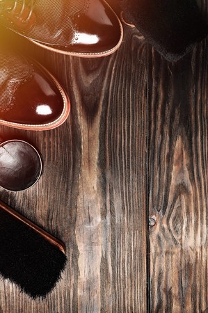 leather shoes on table with polishing equipment. Fashion shoes handmade. Wax. Wooden backgroundの写真素材