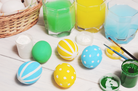Easter eggs in nest on rustic white wooden planksの写真素材