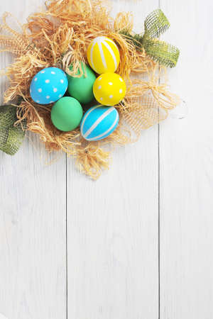 Easter eggs in the nest. rustic white backgroundの写真素材