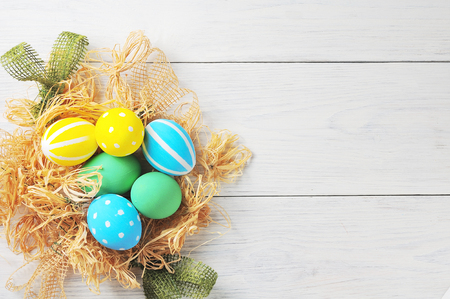 Easter eggs in the nest. rustic white backgroundの写真素材
