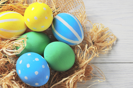 Easter eggs in the nest. rustic white backgroundの写真素材
