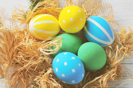 Easter eggs in the nest. rustic white backgroundの写真素材