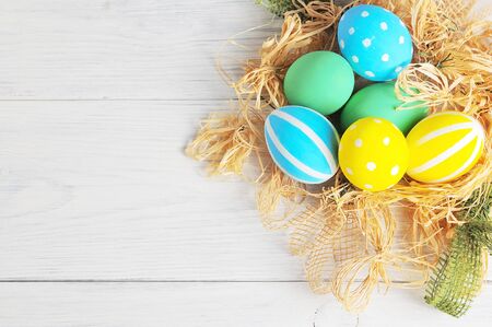 Easter eggs in the nest. rustic white backgroundの写真素材