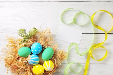 Easter eggs in the nest. rustic white backgroundの写真素材