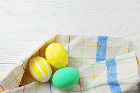 Close up decorating Easter eggs and napkin. rustic white backgroundの写真素材