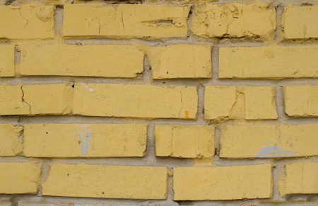 Tiled old painted yellow brick wall background in Kyiv, Ukraineの写真素材