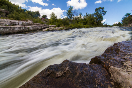 A small rapid at the middle of Hirsky Tikych river with swallow water in Buky, Cherkasy region, Ukraineの写真素材