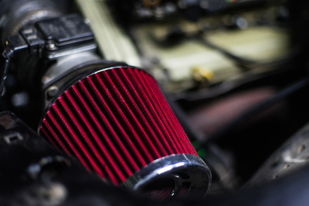 High performance red air filter of sport car with engine on backの写真素材