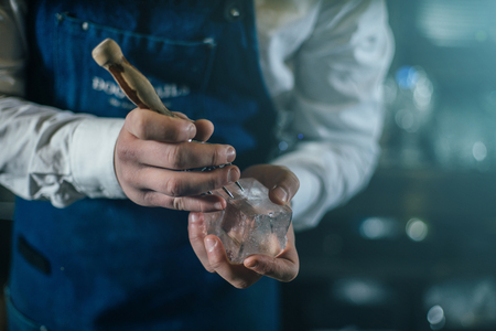 Bartender professionally working with ice to make cold good drinksの写真素材