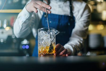 Bartender professionally working with om making drinks and cocktailsの写真素材