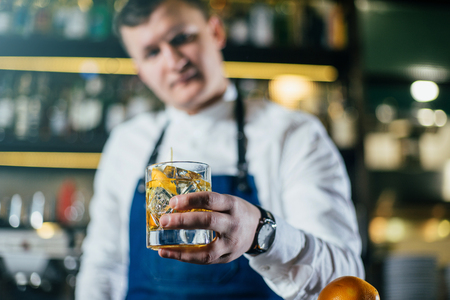 Bartender professionally working with om making drinks and cocktailsの写真素材
