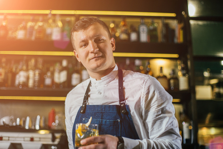 Bartender professionally working with om making drinks and cocktailsの写真素材