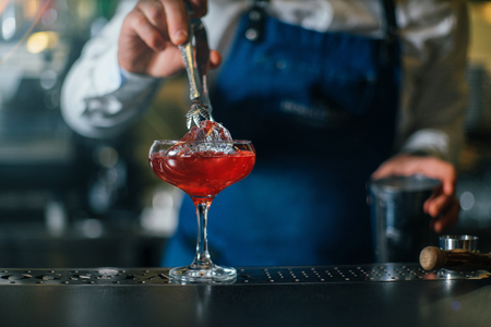 Bartender professionally working with om making drinks and cocktailsの写真素材