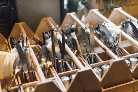Forks, knifes and spoons in restaurants interior. Kitchenwear in close up, ready to service.の写真素材