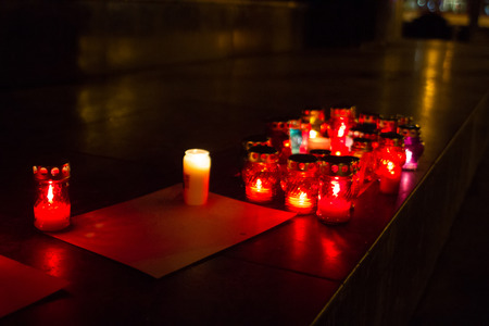 Memory in christian candles in red color and blurred backgroudの写真素材