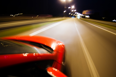 Abstract blurred background with red car and lot of lightsの写真素材
