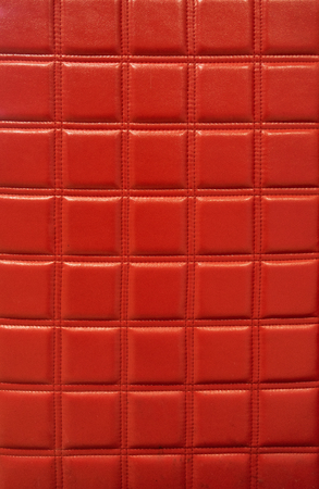 Squared red leather texture with contrast lightの写真素材