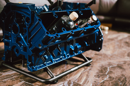 V8 Engine block table, painted in blue color. Loft stylish table furniture with tempered glassの写真素材