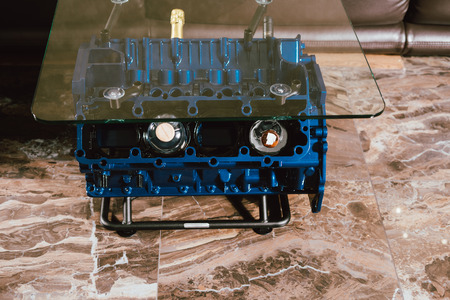 V8 Engine block table, painted in blue color. Loft stylish table furniture with tempered glass