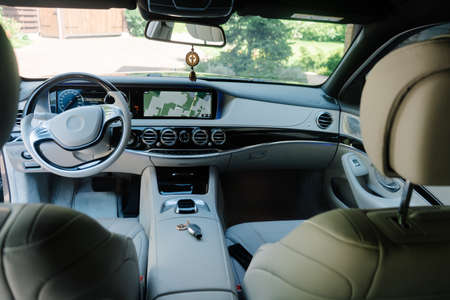 Modern car interior in light colors and navigation device