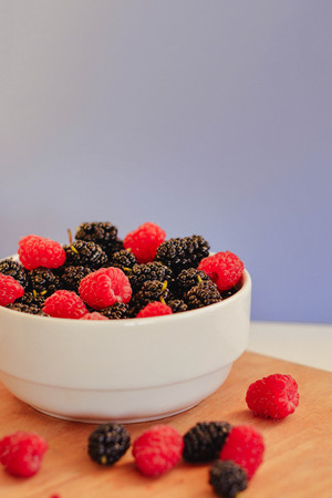 Summer berries in a pialat on wooden backgroundの写真素材