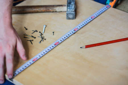Set of instruments for making repair on wooden background in detailsの写真素材
