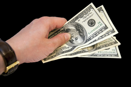 man's hand stretches and bills money hundreds of dollarsの写真素材