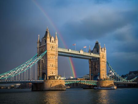 Tower Bridge at sunset with rainbow after storm 