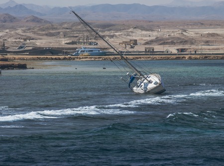 The ship tilted on the seaの写真素材