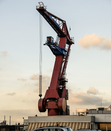 A high floating portal or harbor crane located in open waters at seaport waits for a bulk to provide...