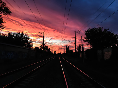 A beautiful urban view of a summer sunset with a pink sky under a railway tracks.  Concept - a way to travel.の写真素材