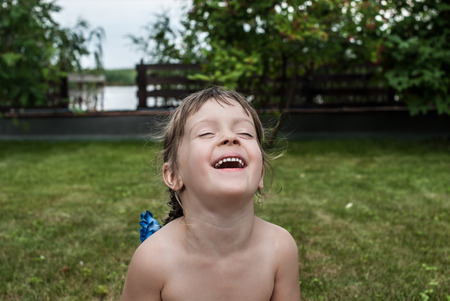 Portrait of a little four-years-old girl. Closeup of a laughing child. Concept - happy childhood.の写真素材