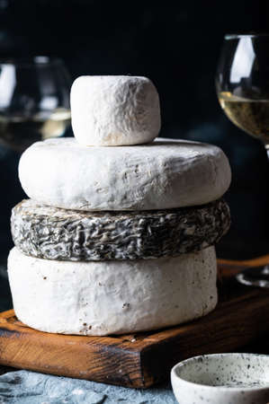 Various types of cheese composition. Gorgonzola, camembert, brie cheese. Roquefort, dor blue. Walnut and wine. Appetizer and gourmet food. Honey in jar.の写真素材