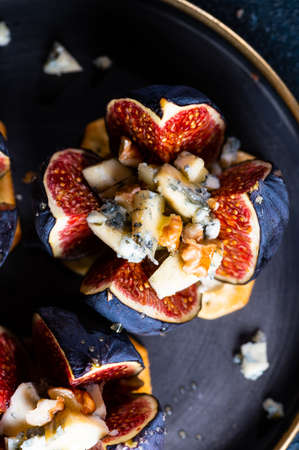 Appetizer with figs and blue cheese. salted cracker. Cheese with honey. Snack and antipasto. Dorblu cheeseの写真素材