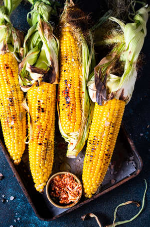 Grilled Corn on the Cob with Salt, paprika and Butter. Organic food, vegetarian meal. Barbecue, bbq....
