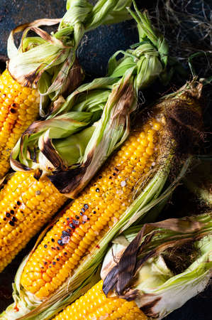 Grilled Corn on the Cob with Salt, paprika and Butter. Organic food, vegetarian meal. Barbecue, bbq. Maize, sweetcorn, grain. Organic food, healthy nutritionの写真素材