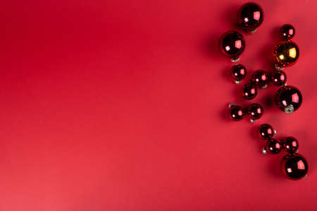 Christmas composition. Christmas red decorations, christmas tree branches on red background. Flat lay, top view, copy space. Christmas flatlay, New year flatlay. New year 2021.の写真素材