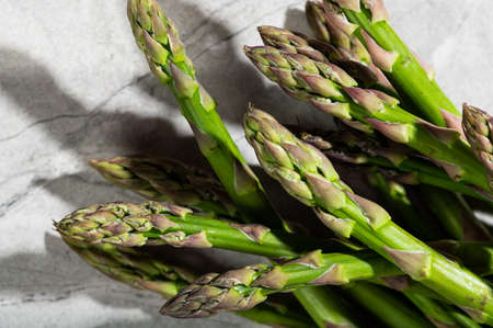 Asparagus on marble background. hard light food photography. Healthy eating concept. Vegetable foodの写真素材