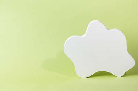 White podium on green background. Template, mock up for presentation products. Pastel colors styled composition with geometrical forms. Minimal concept. Product podium.の写真素材