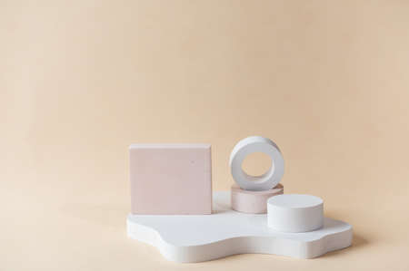 White podium on beige background. Template, mock up for presentation products. Pastel colors styled composition with geometrical forms. Minimal concept. Product podium.の写真素材