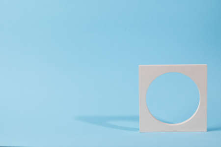 Minimal abstract cosmetic background for product presentation. Cosmetic bottle podium on blue background. Pastel colors styled composition with geometrical forms. Minimal concept. Product mockup.の写真素材