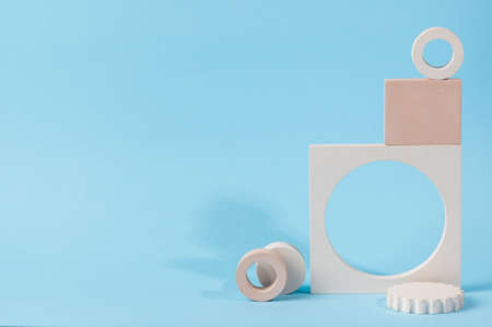 Minimal abstract cosmetic background for product presentation. Cosmetic bottle podium on blue background. Pastel colors styled composition with geometrical forms. Minimal concept. Product mockup.の写真素材
