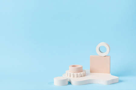 Minimal abstract cosmetic background for product presentation. Cosmetic bottle podium on blue background. Pastel colors styled composition with geometrical forms. Minimal concept. Product mockup.の写真素材