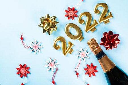 2022 number with champagne bottle and decor. Happy new year and festive concept. Top horizontal...